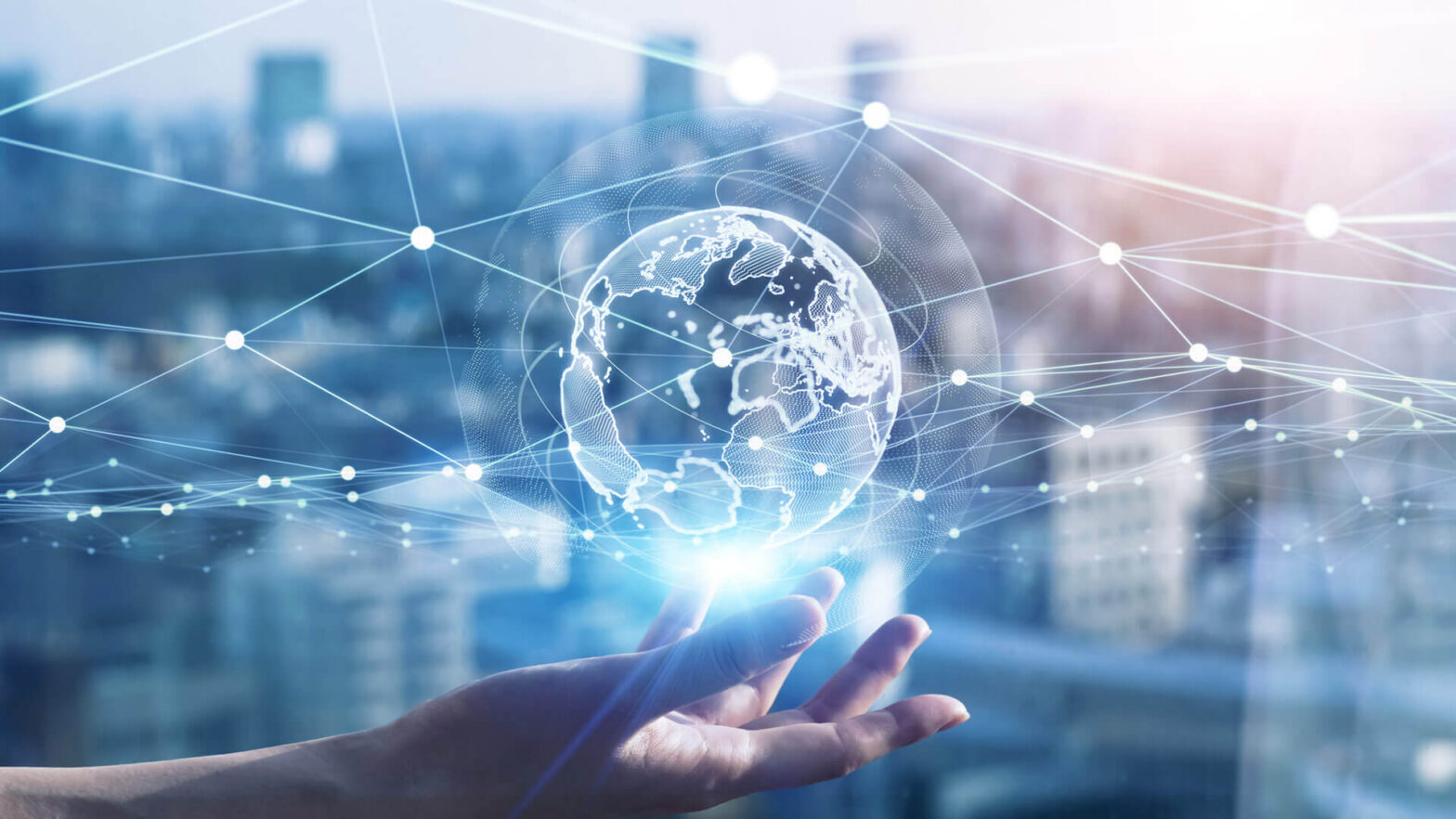 A hand holds a glowing digital globe with network lines and nodes, symbolizing global connectivity and the seamless communication enabled by the best SMS gateways Switzerland offers, against a blurred cityscape background.